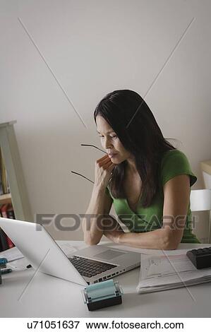 Stock Photo - Woman working with laptop. Fotosearch