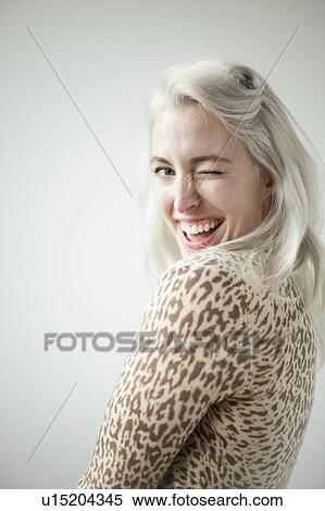 Stock Photography - Young attractive woman blinking in front of camera. Fotosearch