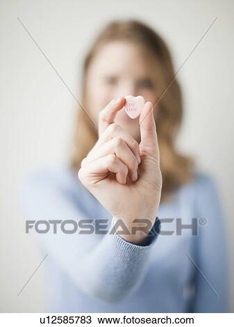 Young attractive woman showing heart with love inscription View Large Photo Image Stock Image - Young attractive woman showing heart with love inscription. Fotosearch