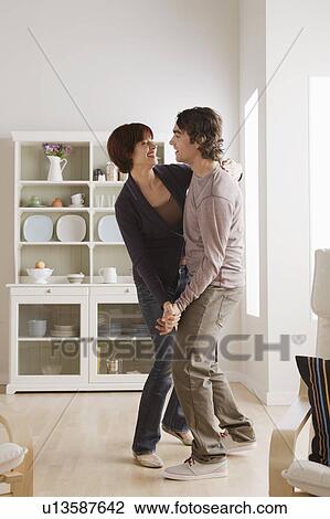 Young couple dancing at home View Large Photo Image Stock Image - Young couple dancing at home. Fotosearch