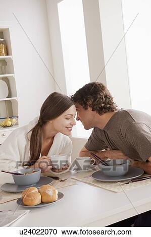 Stock Image - Young couple eating breakfast. Fotosearch