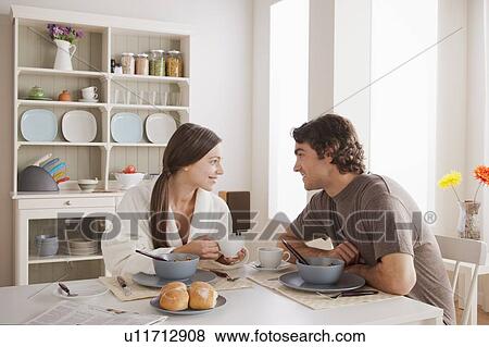 Stock Photo - Young couple eating breakfast. Fotosearch