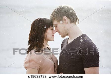 Young couple embracing in rain View Large Photo Image Stock Photo - Young couple embracing in rain. Fotosearch