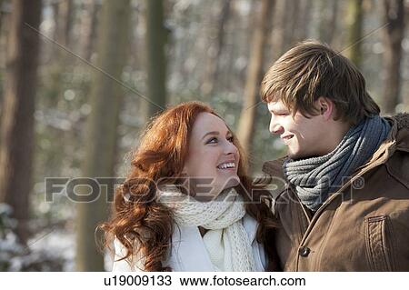 Young couple embracing in winter scenery View Large Photo Image Stock Image - Young couple embracing in winter scenery. Fotosearch