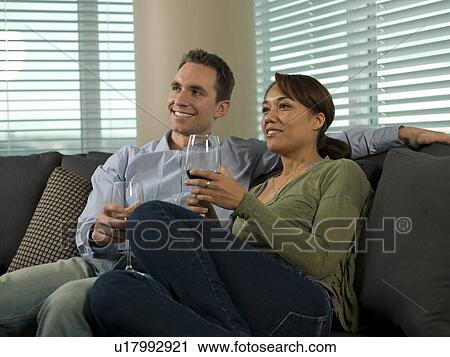 Young couple enjoying wine at home View Large Photo Image Stock Image - Young couple enjoying wine at home. Fotosearch