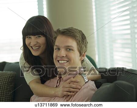 Stock Photo - Young couple smiling in their home. Fotosearch