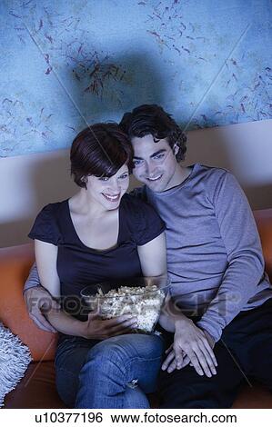 Young couple watching TV View Large Photo Image Stock Photograph - Young couple watching TV. Fotosearch