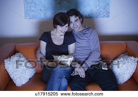 Young couple watching TV View Large Photo Image Stock Photography - Young couple watching TV. Fotosearch