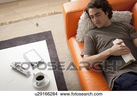 Young man sleeping on sofa View Large Photo Image Picture - Young man sleeping on sofa. Fotosearch