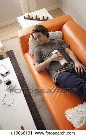 Young man sleeping on sofa View Large Photo Image Stock Image - Young man sleeping on sofa. Fotosearch