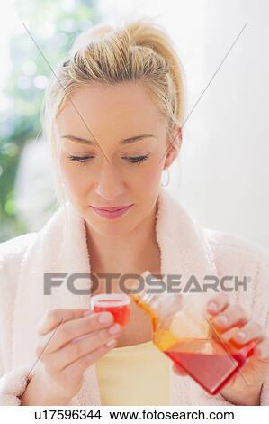 Young pouring liquid View Large Photo Image Picture - Young pouring liquid. Fotosearch