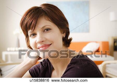 Young smiling woman looking at camera View Large Photo Image Stock Photograph - Young smiling woman looking at camera. Fotosearch