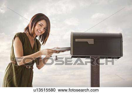 Young woman at mailbox View Large Photo Image Stock Image - Young woman at mailbox. Fotosearch