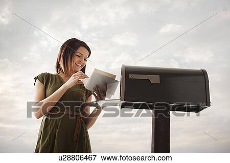 Young woman at mailbox View Large Photo Image Stock Photo - Young woman at mailbox. Fotosearch