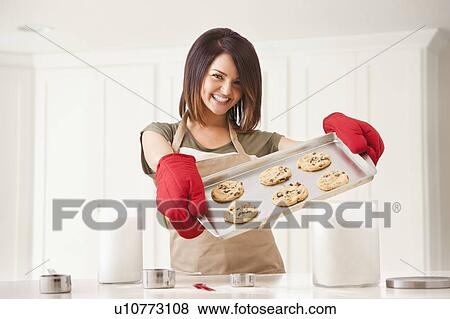 Young woman baking cookies View Large Photo Image Stock Photo - Young woman baking cookies. Fotosearch