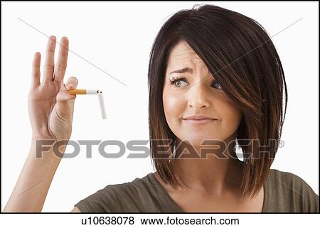Young woman breaking cigarette View Large Photo Image Stock Photo - Young woman breaking cigarette. Fotosearch