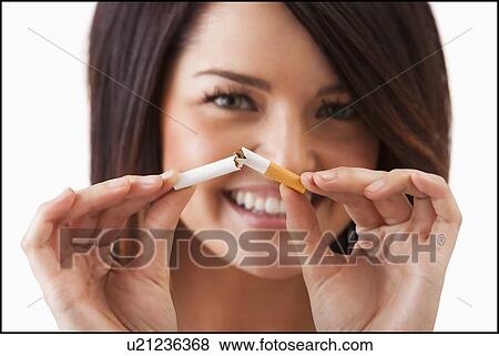 Young woman breaking cigarette View Large Photo Image Stock Photo - Young woman breaking cigarette. Fotosearch