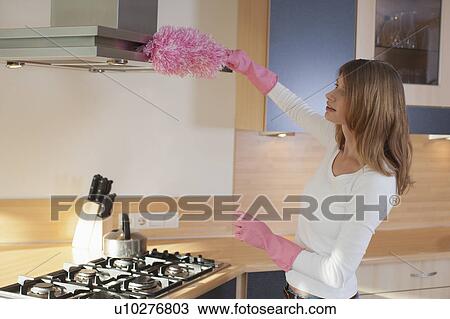 Young woman cleaning kitchen View Large Photo Image Stock Image - Young woman cleaning kitchen. Fotosearch