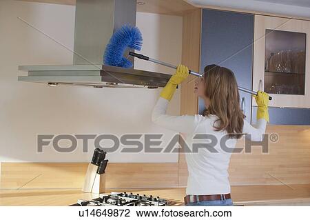 Young woman cleaning the kitchen View Large Photo Image Stock Image - Young woman cleaning the kitchen. Fotosearch