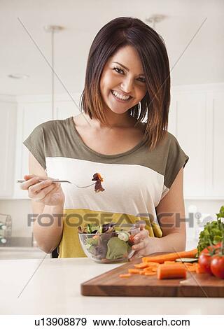 Young woman cutting vegetables View Large Photo Image Stock Photo - Young woman cutting vegetables. Fotosearch