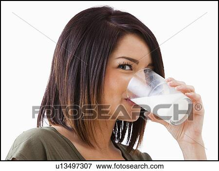 Young woman drinking milk View Large Photo Image Stock Photo - Young woman drinking milk. Fotosearch