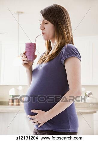 Picture - Young woman drinking smoothie. Fotosearch