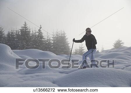 Young woman hiking in winter scenery View Large Photo Image Stock Image - Young woman hiking in winter scenery. Fotosearch