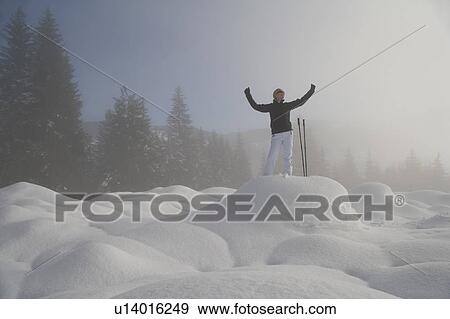 Stock Photo - Young woman hiking in winter scenery. Fotosearch