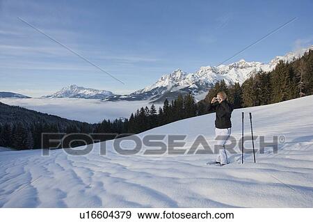 Stock Photo - Young woman hiking in winter scenery. Fotosearch