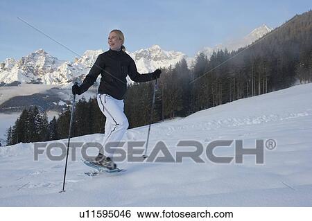 Stock Photograph - Young woman hiking in winter scenery. Fotosearch