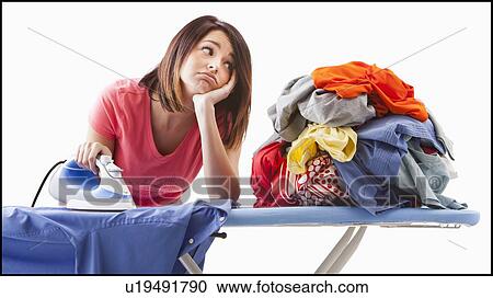 Stock Image - Young woman ironing. Fotosearch