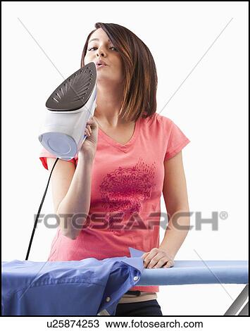Stock Image - Young woman ironing. Fotosearch
