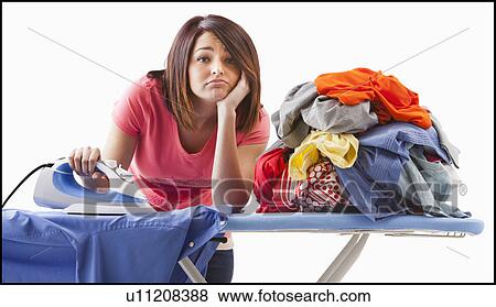 Young woman ironing View Large Photo Image Stock Photo - Young woman ironing. Fotosearch