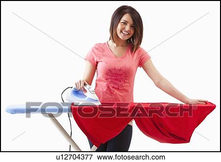 Young woman ironing View Large Photo Image Stock Photo - Young woman ironing. Fotosearch
