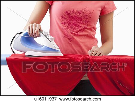 Young woman ironing View Large Photo Image Stock Photo - Young woman ironing. Fotosearch