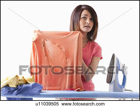 Young woman ironing View Large Photo Image Stock Photography - Young woman ironing. Fotosearch
