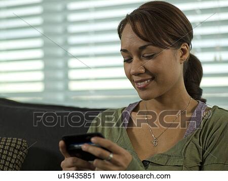 Young woman looking content View Large Photo Image Stock Image - Young woman looking content. Fotosearch