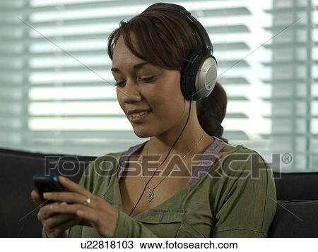 Stock Image - Young woman looking content. Fotosearch
