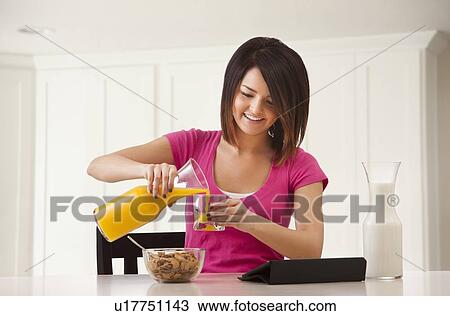 Young woman preparing breakfast View Large Photo Image Stock Image - Young woman preparing breakfast. Fotosearch