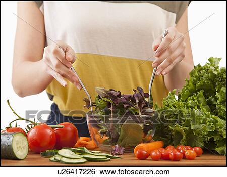 Young woman preparing salad View Large Photo Image Stock Photograph - Young woman preparing salad. Fotosearch