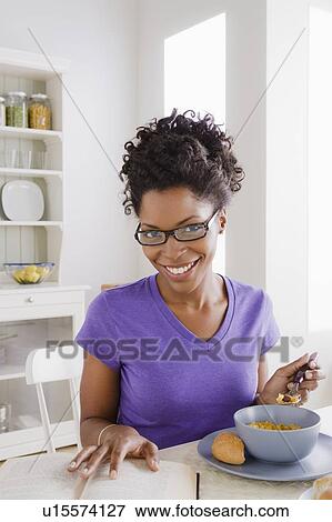 Stock Photo - Young woman reading book. Fotosearch