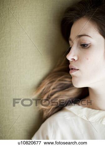 Young woman relaxing on sofa View Large Photo Image Stock Photo - Young woman relaxing on sofa. Fotosearch