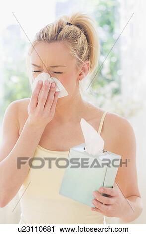 Young woman sneezing View Large Photo Image Stock Image - Young woman sneezing. Fotosearch