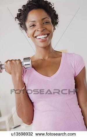 Young woman training at home View Large Photo Image Stock Image - Young woman training at home. Fotosearch
