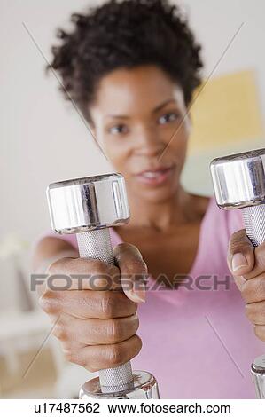 Young woman training at home View Large Photo Image Stock Image - Young woman training at home. Fotosearch