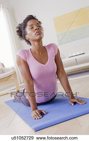 Young woman training at home View Large Photo Image Stock Photo - Young woman training at home. Fotosearch