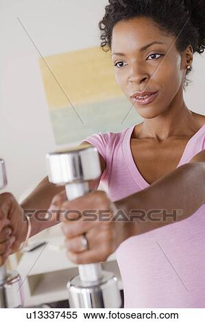 Young woman training at home View Large Photo Image Stock Photography - Young woman training at home. Fotosearch