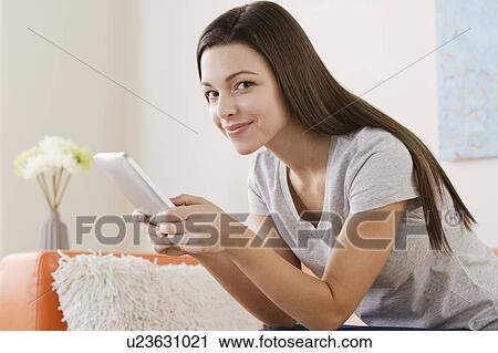 Young woman using digital tablet View Large Photo Image Stock Image - Young woman using digital tablet . Fotosearch