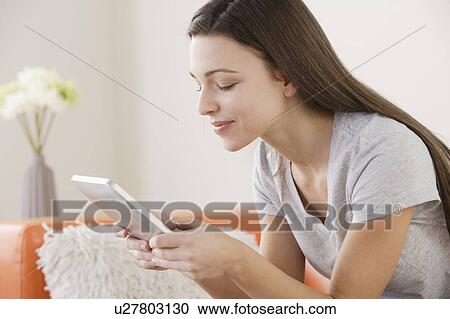 Young woman using digital tablet View Large Photo Image Stock Image - Young woman using digital tablet . Fotosearch