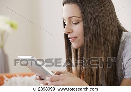 Stock Photo - Young woman using digital tablet . Fotosearch